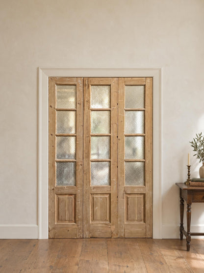 Antique Textured Glass Raised Panel Tri-Fold Doors - 55.5x84 - N835 shown installed in a room (digital preview)